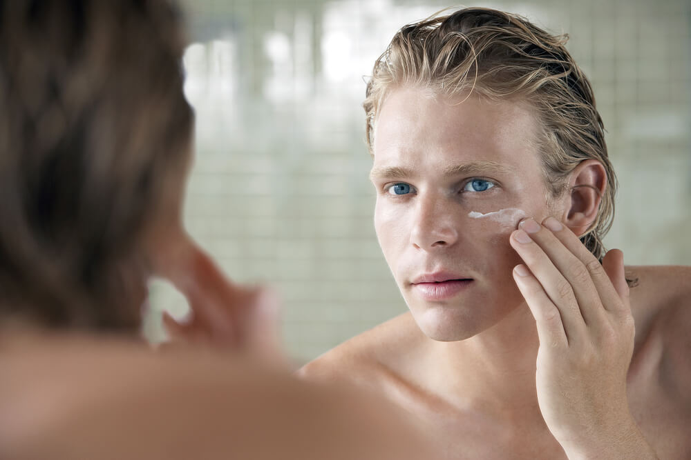 man applying skincare