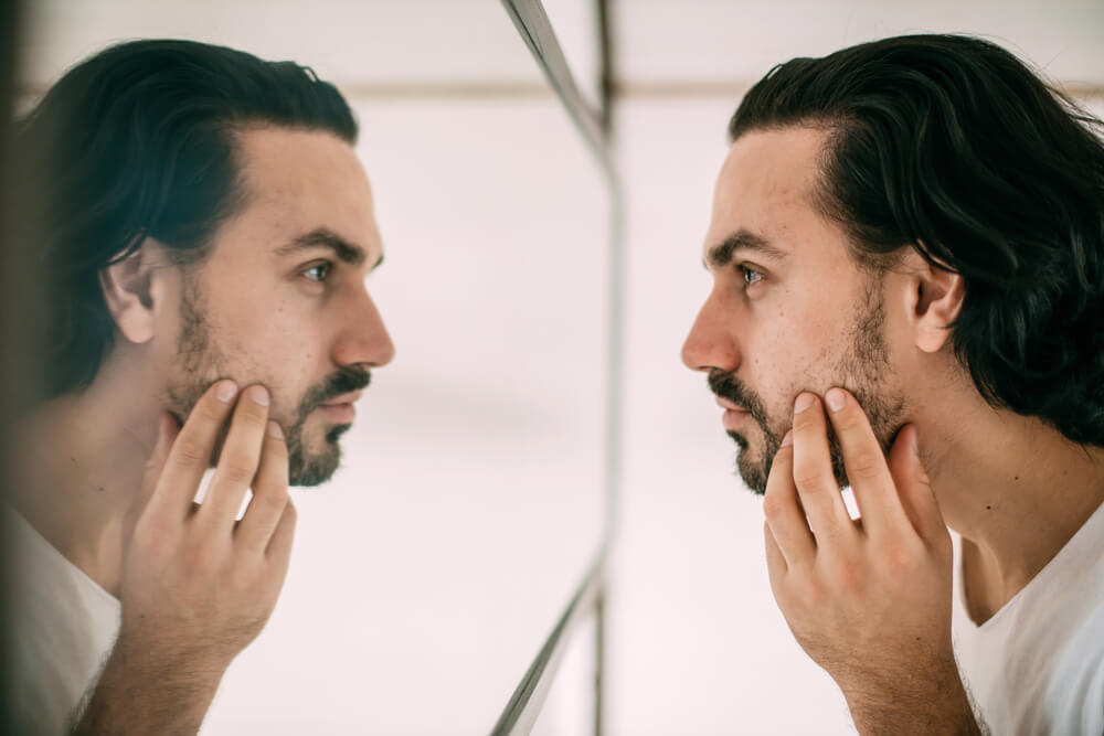 man looking in mirror