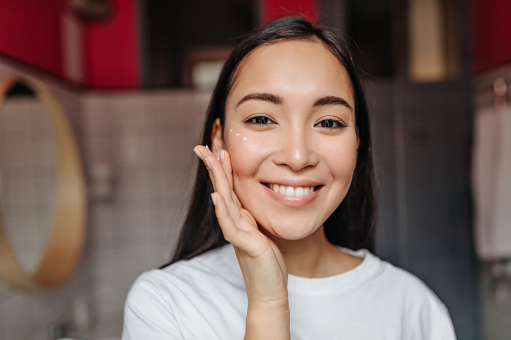 Woman applying eye cream