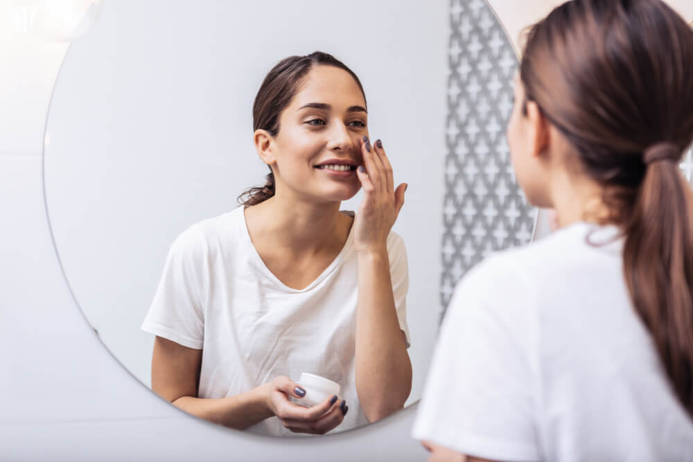 Woman applying face cream